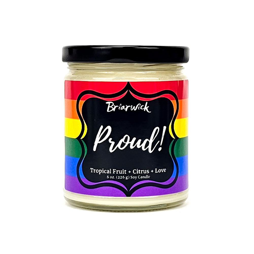PROUD! 8oz white candle with rainbow pride flag on a white background