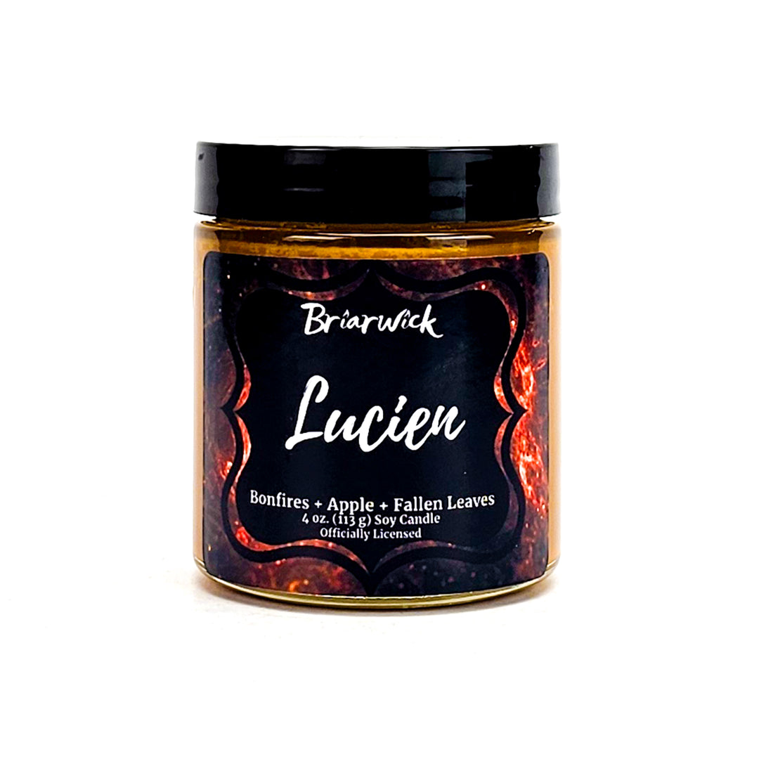 Lucien 4oz burnt orange candle with orange galaxy design on a white background