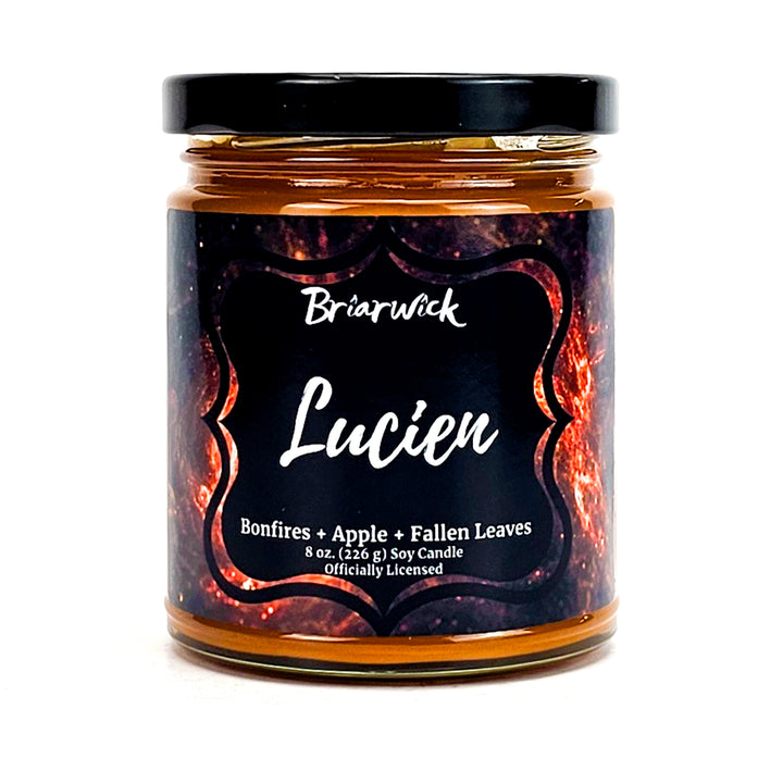 Lucien 8oz burnt orange candle with orange galaxy design on a white background