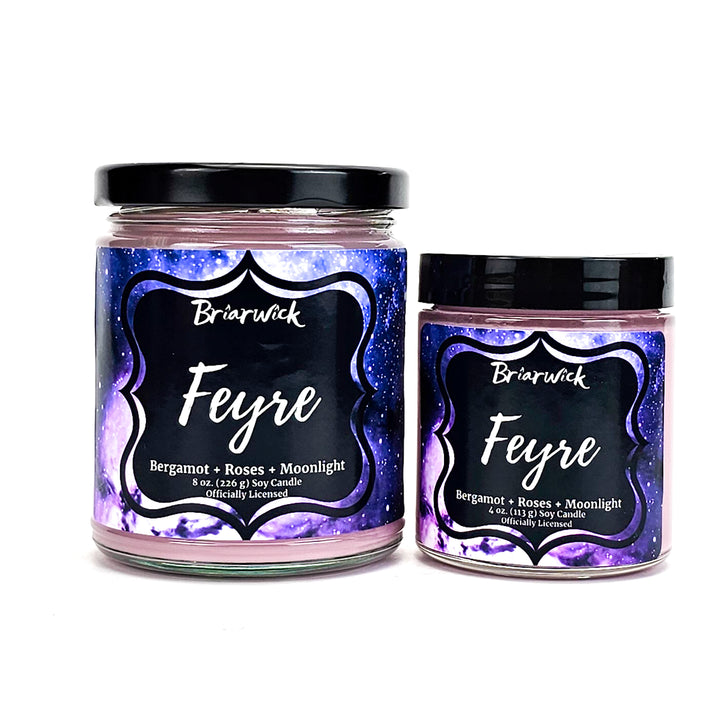 Feyre 8oz & 4oz powder pink candles with purple galaxy designs on a white background
