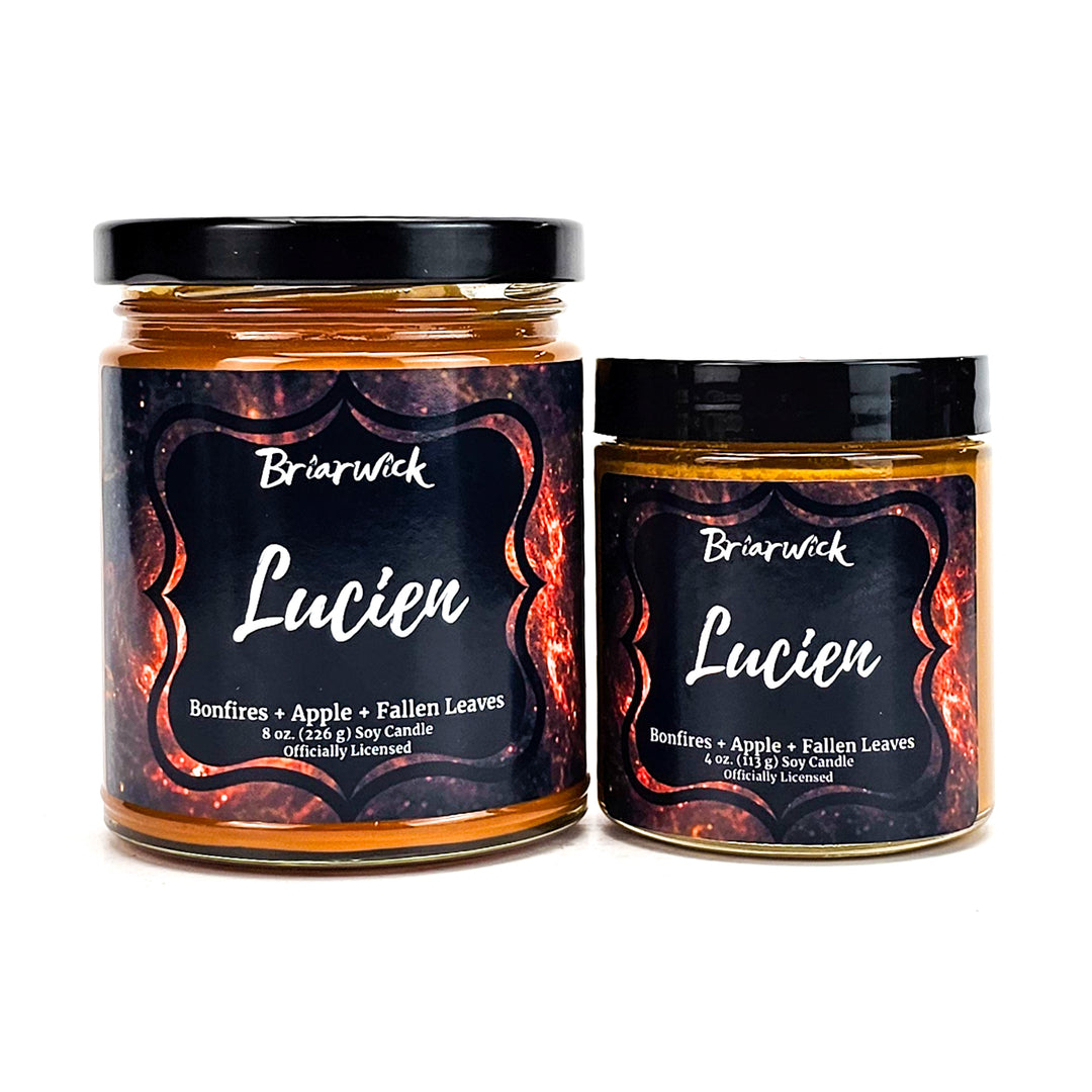 Lucien 8oz & 4oz burnt orange candles with orange galaxy designs on a white background