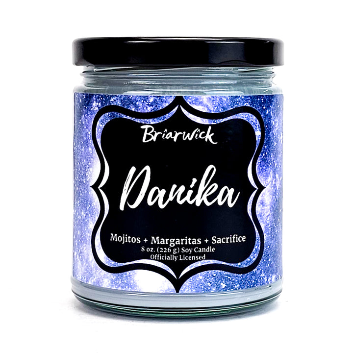 a jar of purple and blue glitter with a black lid
