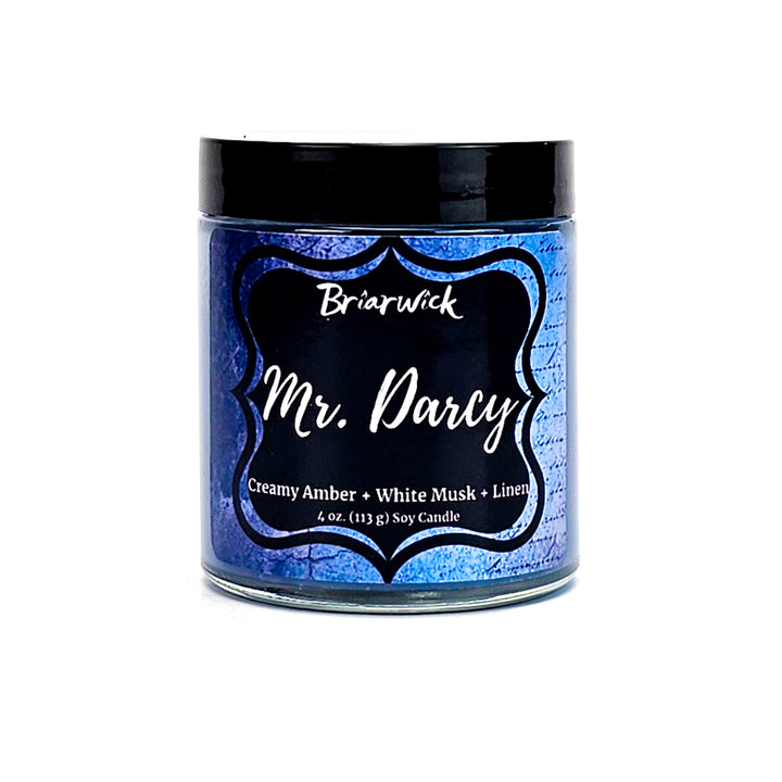 Mr. Darcy 4oz steel blue candle with blue parchment design on a white background
