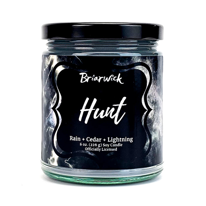 Hunt 8oz silver candle with gray storm design on a white background