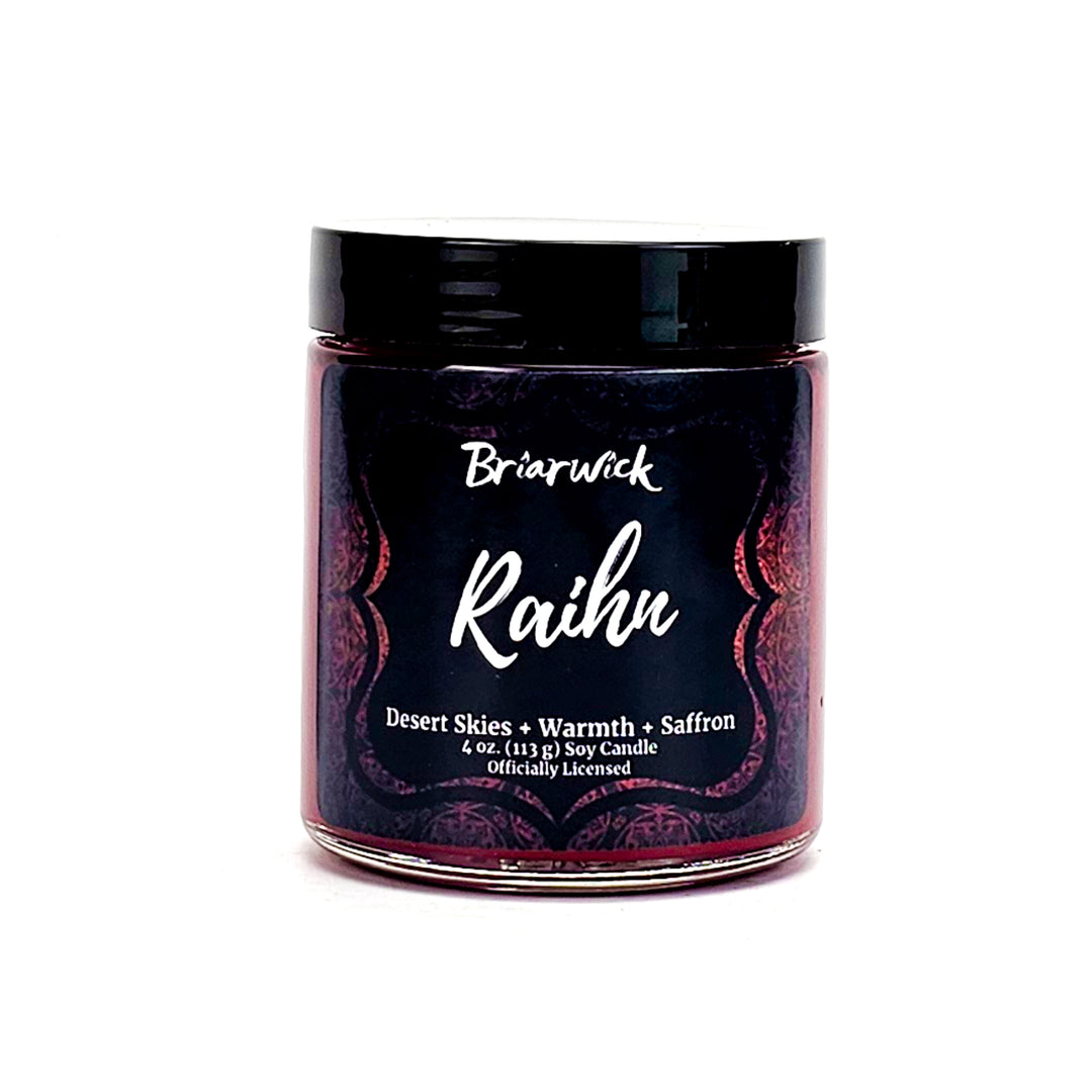 Raihn 4oz garnet candle with red ornamental design on a white background