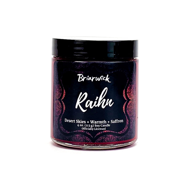 Raihn 4oz garnet candle with red ornamental design on a white background