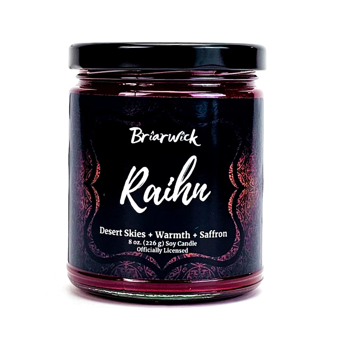 Raihn 8oz garnet candle with red ornamental design on a white background