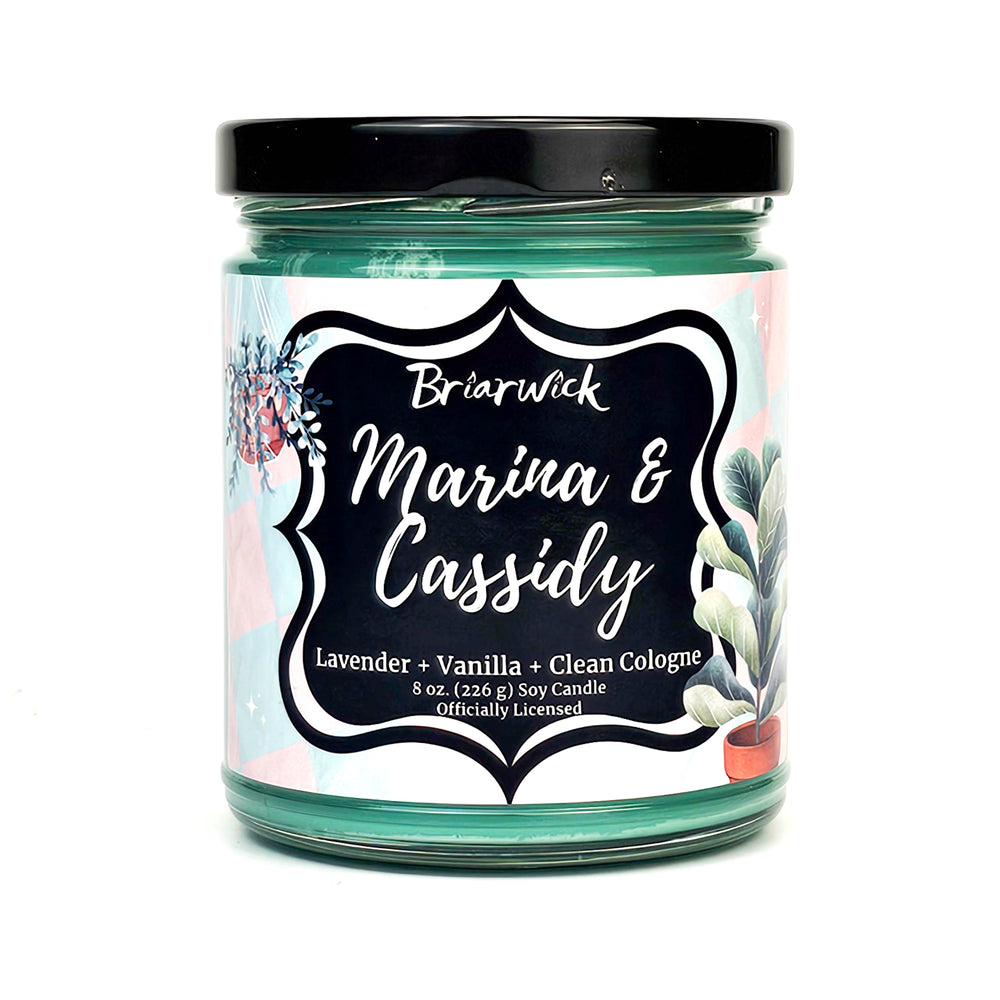 Marina & Cassidy 8oz blue green candle with pink/blue checker design on a white background