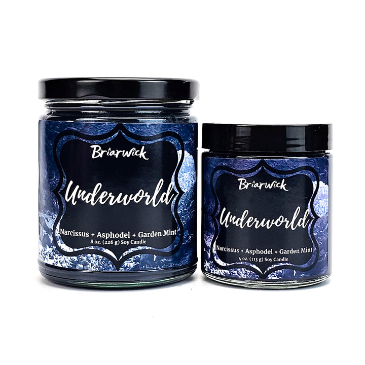 two jars of blue colored candles with black lids