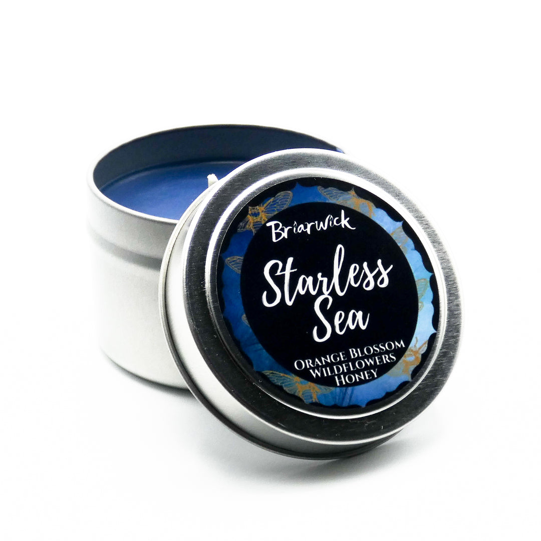 a tin of starless sea candle sitting on a white surface