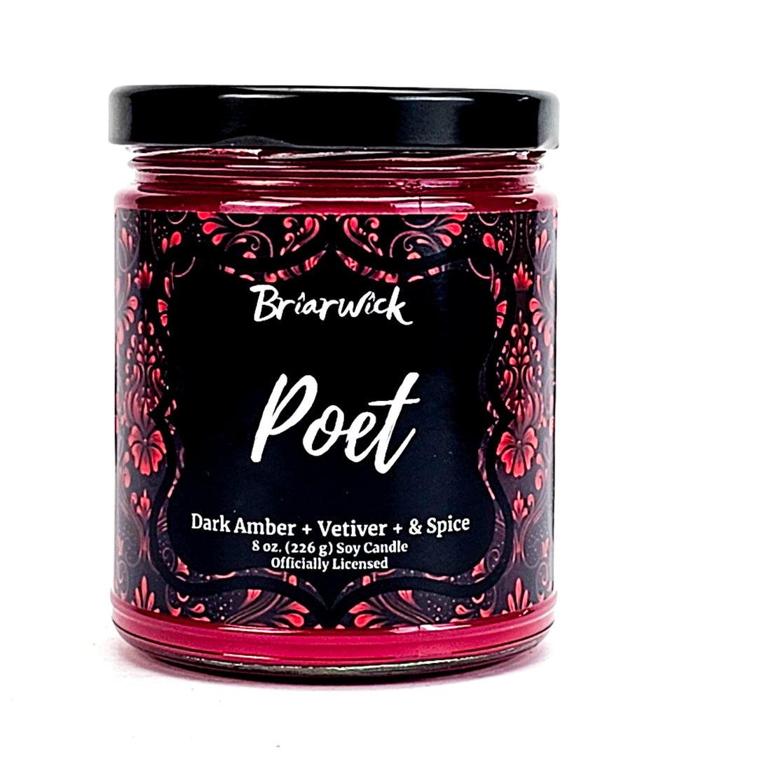 Poet 8oz cherry red candle with red ornamental design on a white background