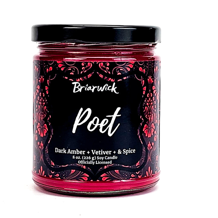Poet 8oz cherry red candle with red ornamental design on a white background