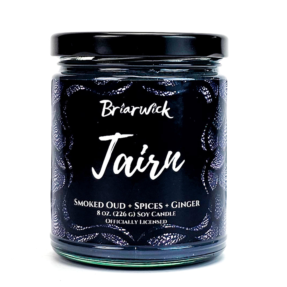 Tairn 8oz flint gray candle with gray dragon scale design on a white background