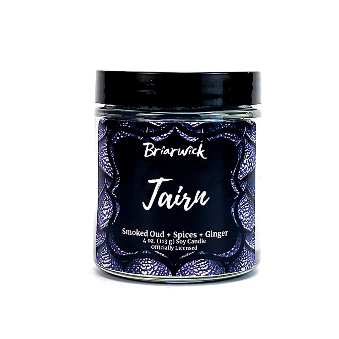 Tairn 4oz flint gray candle with gray dragon scale design on a white background