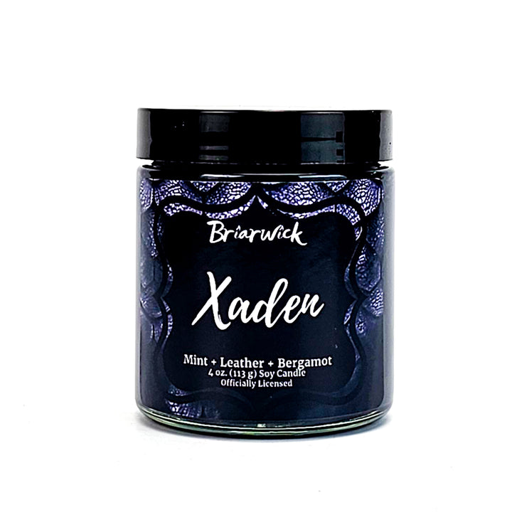 Xaden 4oz black candle with black dragon scale design on a white background