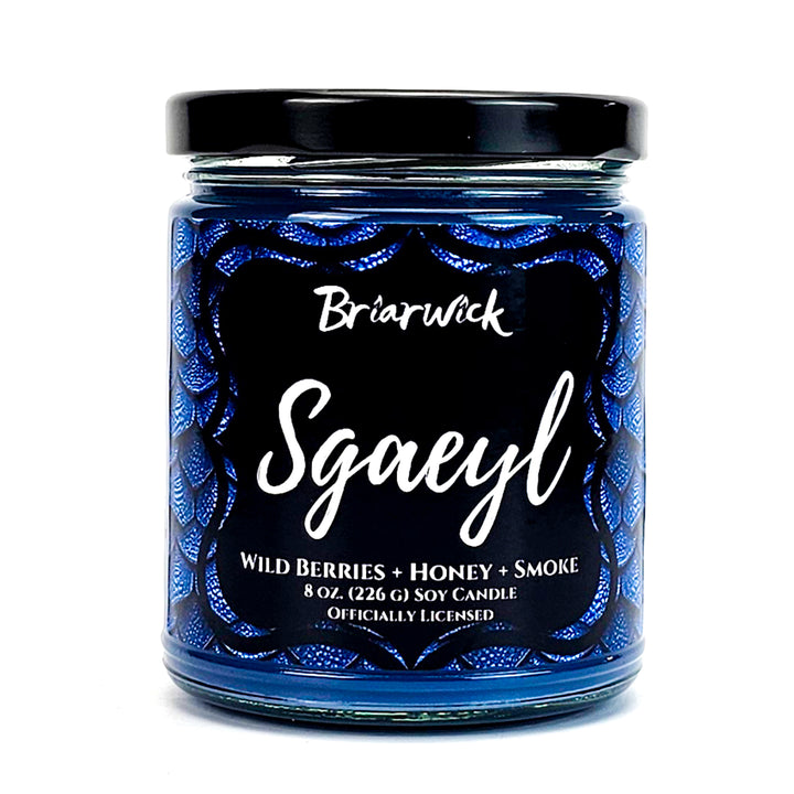 Sgaeyl 8oz navy candle with blue dragon scale design on a white background