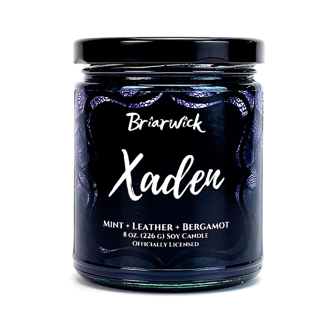 Xaden 8oz black candle with black dragon scale design on a white background