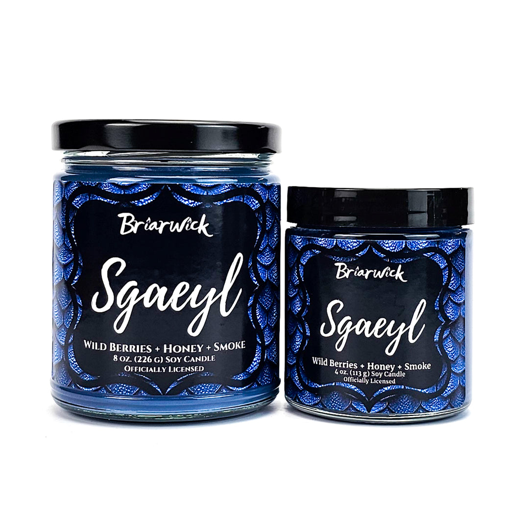 Sgaeyl 8oz & 4oz navy candles with blue dragon scale designs on a white background