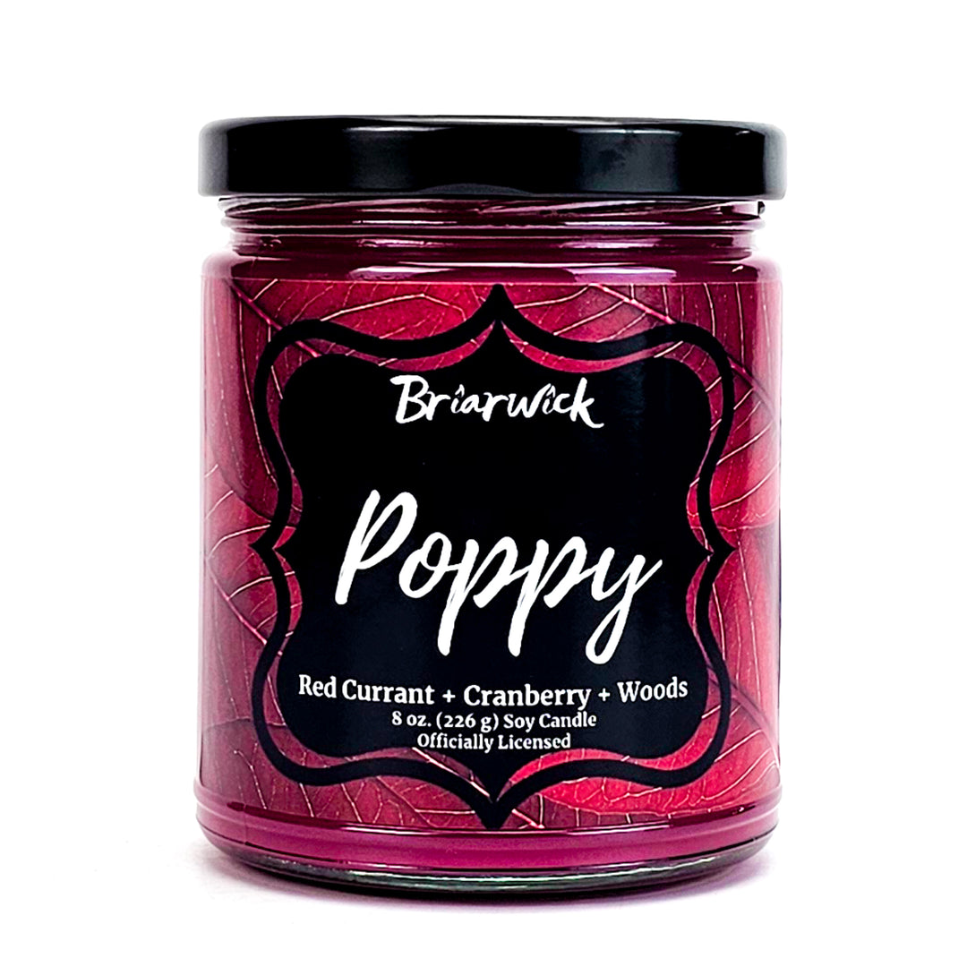 Poppy 8oz burgundy candle with red leaf design on a white background