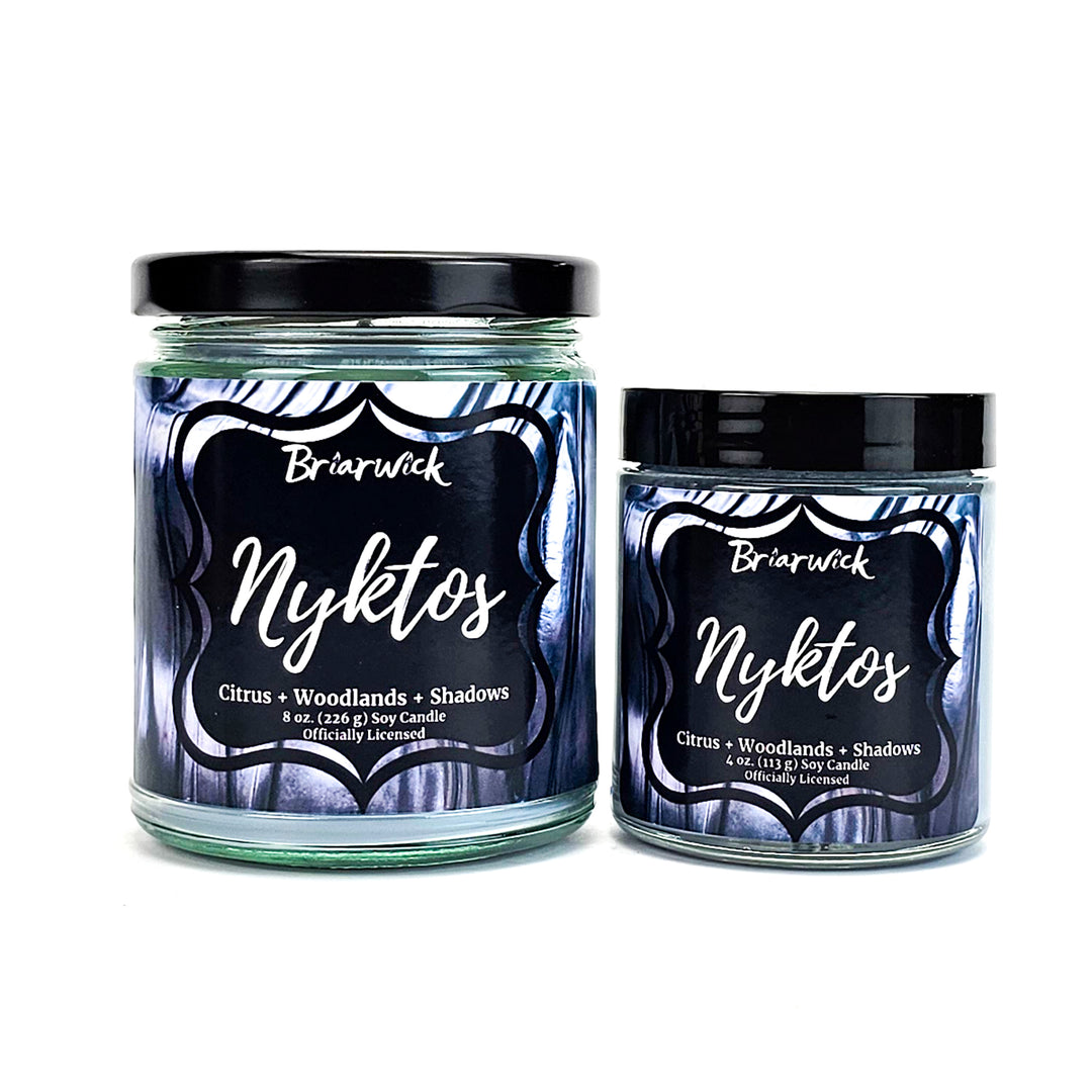 Nyktos 8oz & 4oz flint gray candles with black & white textured designs on a white background