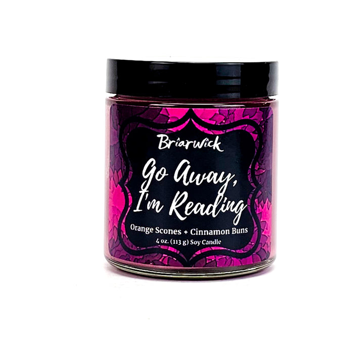 Go Away, I’m Reading 4oz magenta candle with magenta floral design on a white background