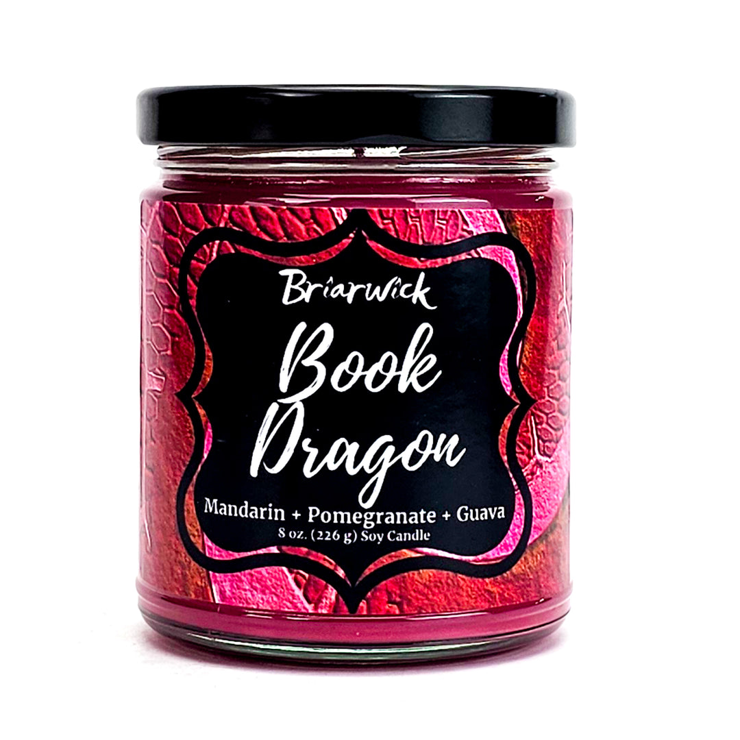 Book Dragon 8oz maroon candle with maroon scale design on a white background