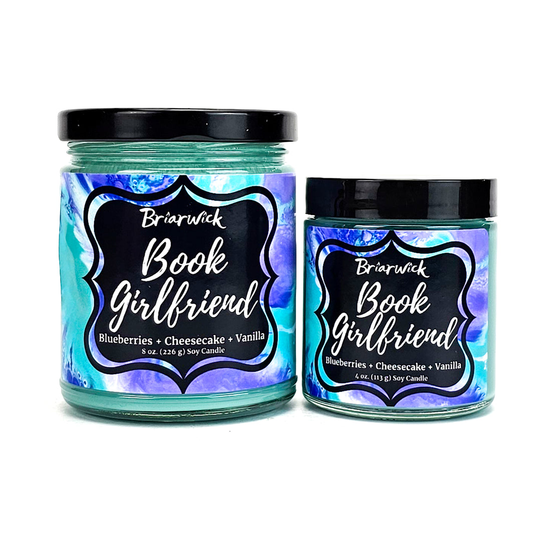 Book Girlfriend 8oz & 4oz seafoam candles with blue textured designs on a white background
