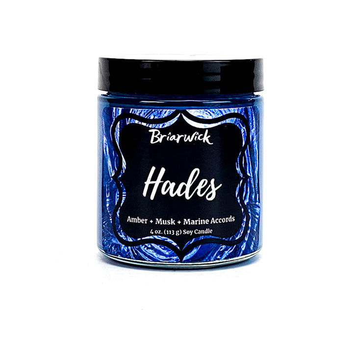 Hades 4oz navy candle with blue spiral design on a white background