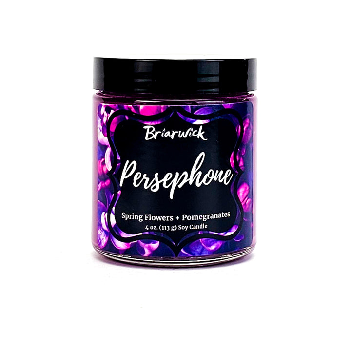 Persephone 4oz crocus purple candle with a purple flower design on a white background