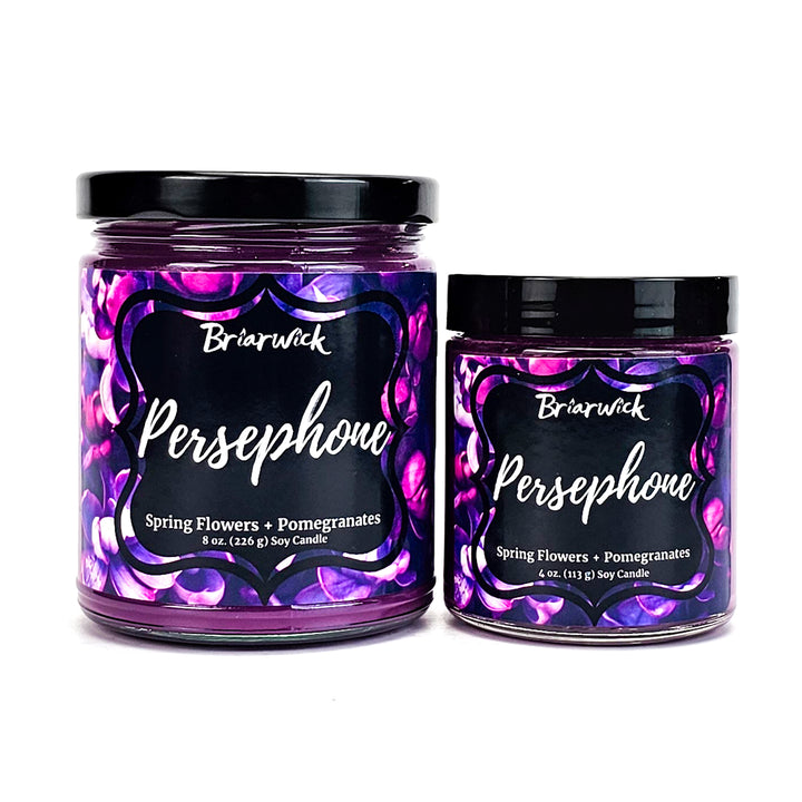 Persephone 8oz & 4oz crocus purple candles with a purple flower designs on a white background