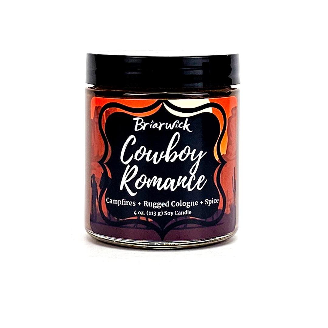Cowboy Romance 4oz chocolate brown candle with desert scene design on a white background