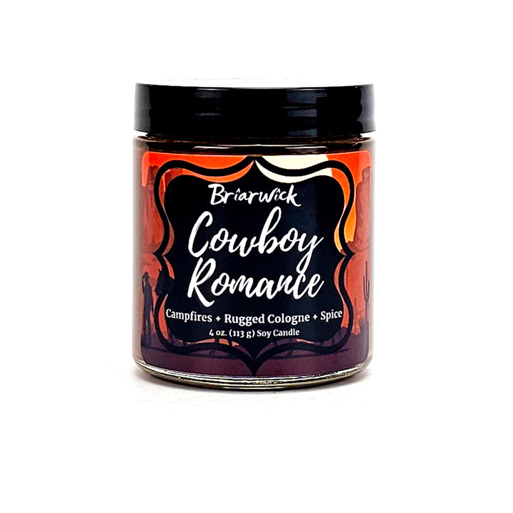 Cowboy Romance 4oz chocolate brown candle with desert scene design on a white background