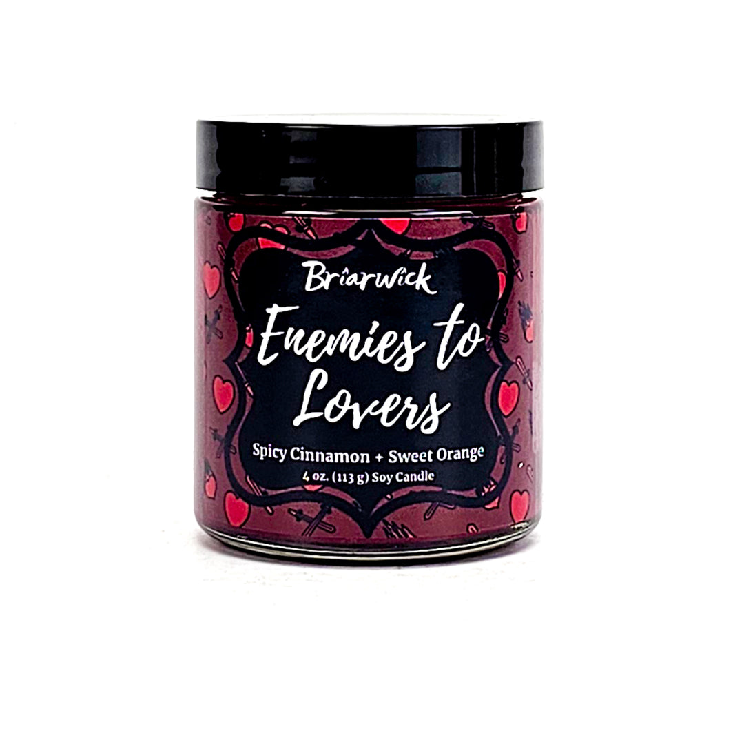Enemies To Lovers 4oz red wine candle with red heart/sword design on a white background
