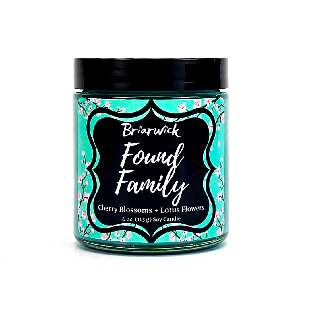 Found Family 8oz turquoise candle with turquoise cherry blossom design on a white background