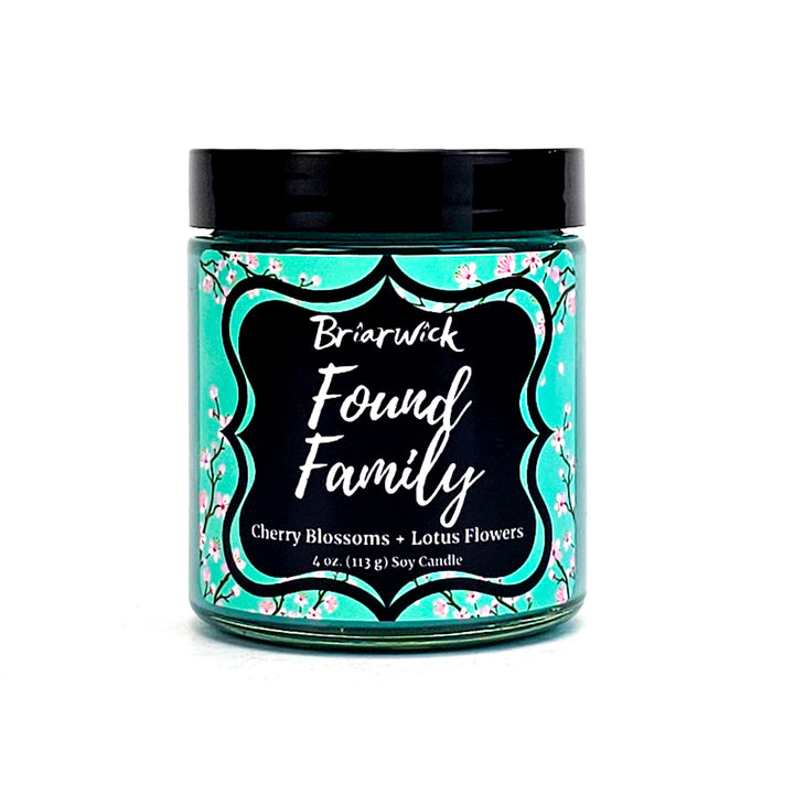 Found Family 8oz turquoise candle with turquoise cherry blossom design on a white background
