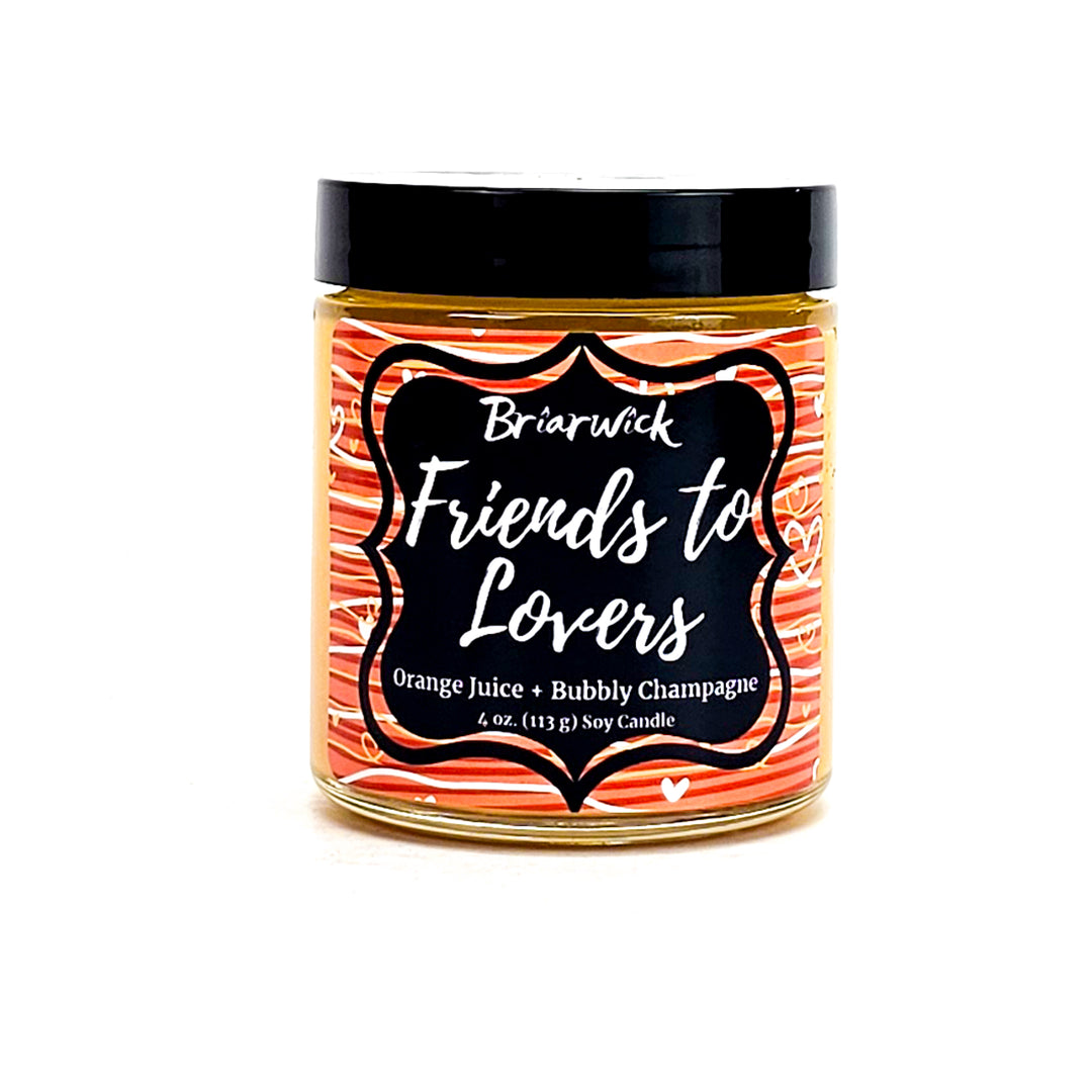 Friends-To-Lovers 4oz yellow mustard candle with white & orange line design on a white background