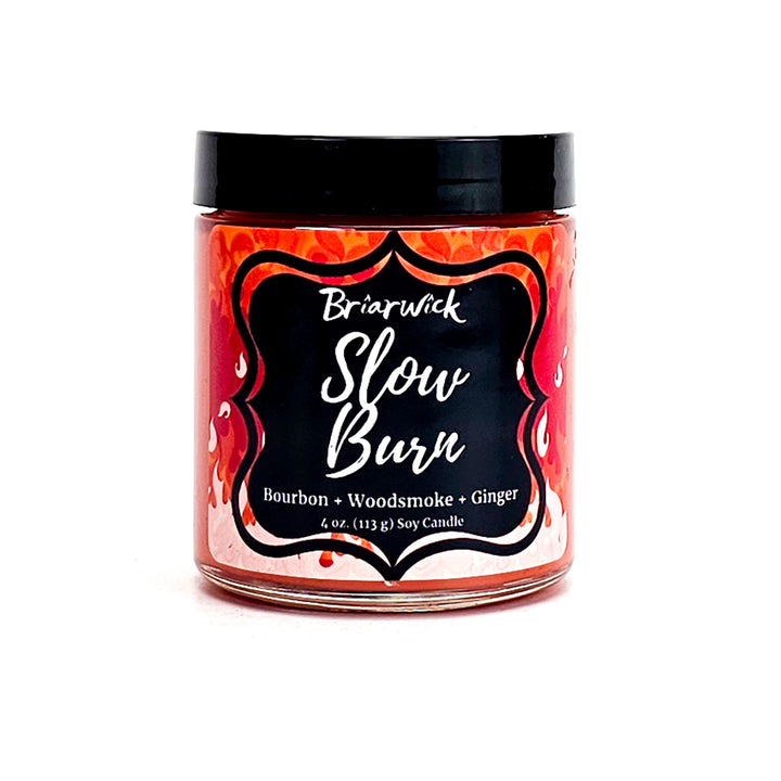 Slow Burn 4oz persimmon candle with orange flame design on a white background