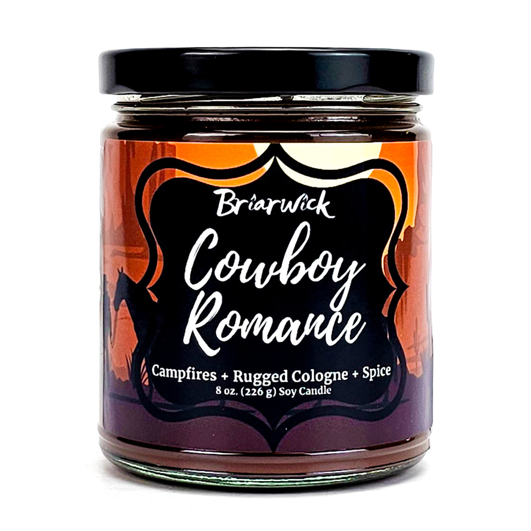 Cowboy Romance 8oz chocolate brown candle with desert scene design on a white background