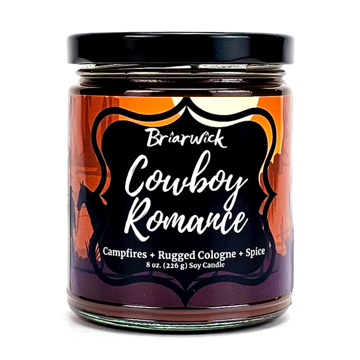 Cowboy Romance 8oz chocolate brown candle with desert scene design on a white background