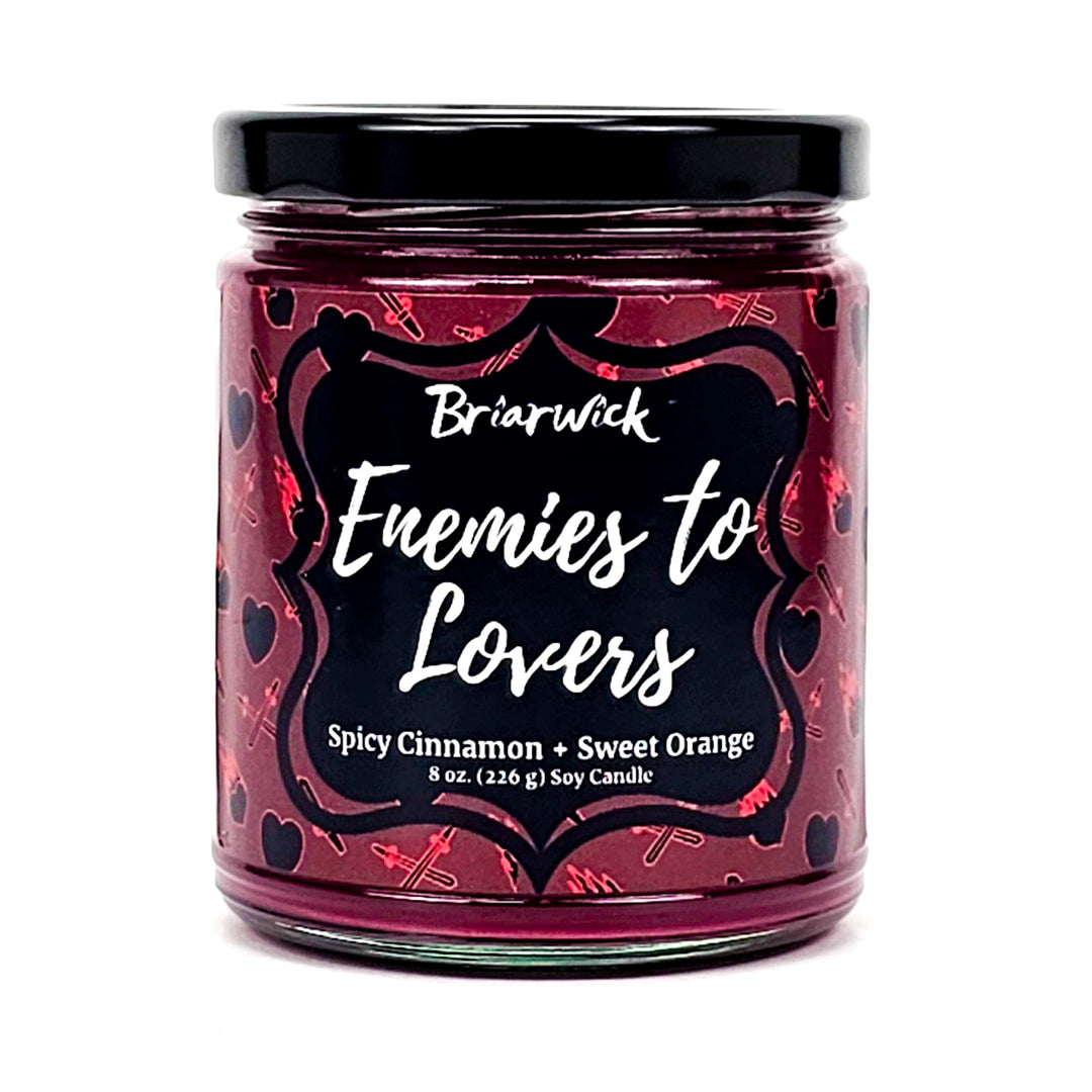 Enemies To Lovers 8oz red wine candle with red heart/sword design on a white background