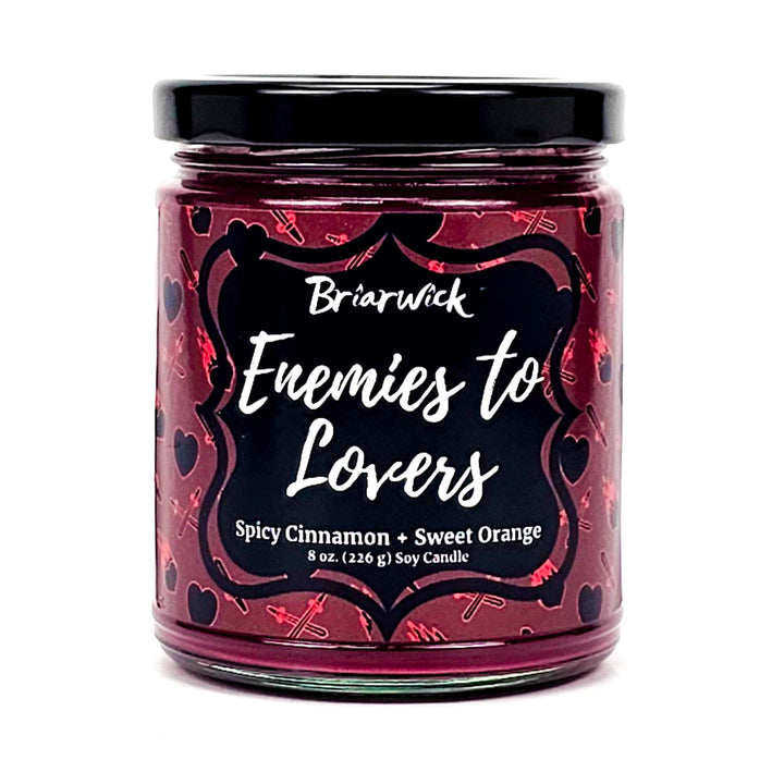 Enemies To Lovers 8oz red wine candle with red heart/sword design on a white background