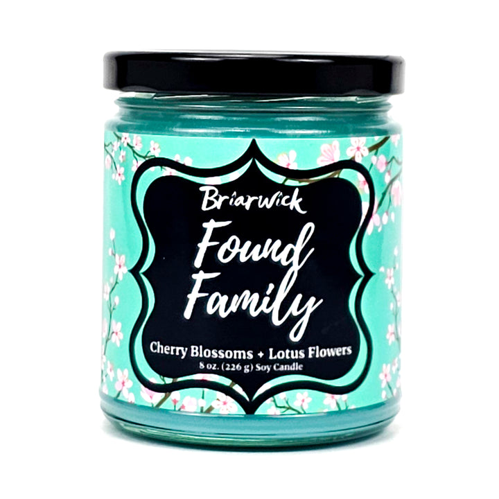 Found Family 8oz turquoise candle with turquoise cherry blossom design on a white background