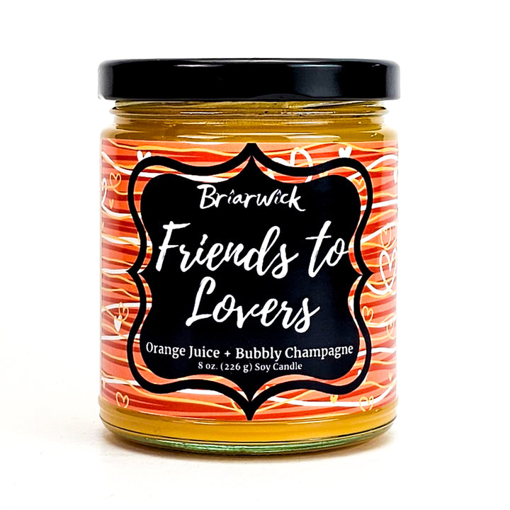 Friends-To-Lovers 8oz yellow mustard candle with white & orange line design on a white background
