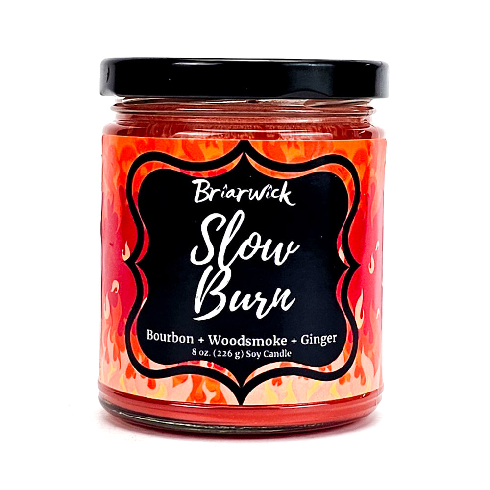 Slow Burn 8oz persimmon candle with orange flame design on a white background