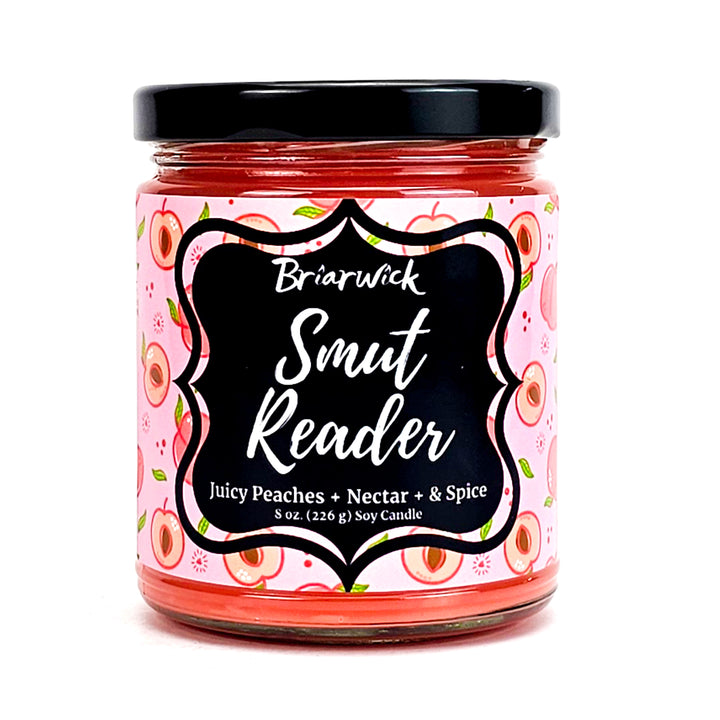 Smut Reader 8oz dark peach candle with pink peach design on a white background