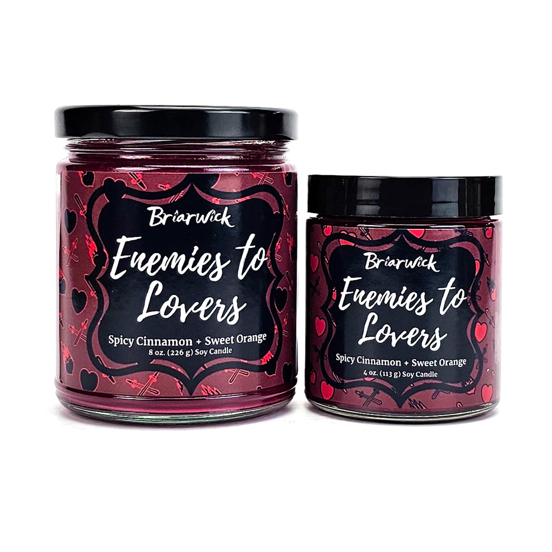 Enemies To Lovers 8oz & 4oz red wine candles with red heart/sword designs on a white background
