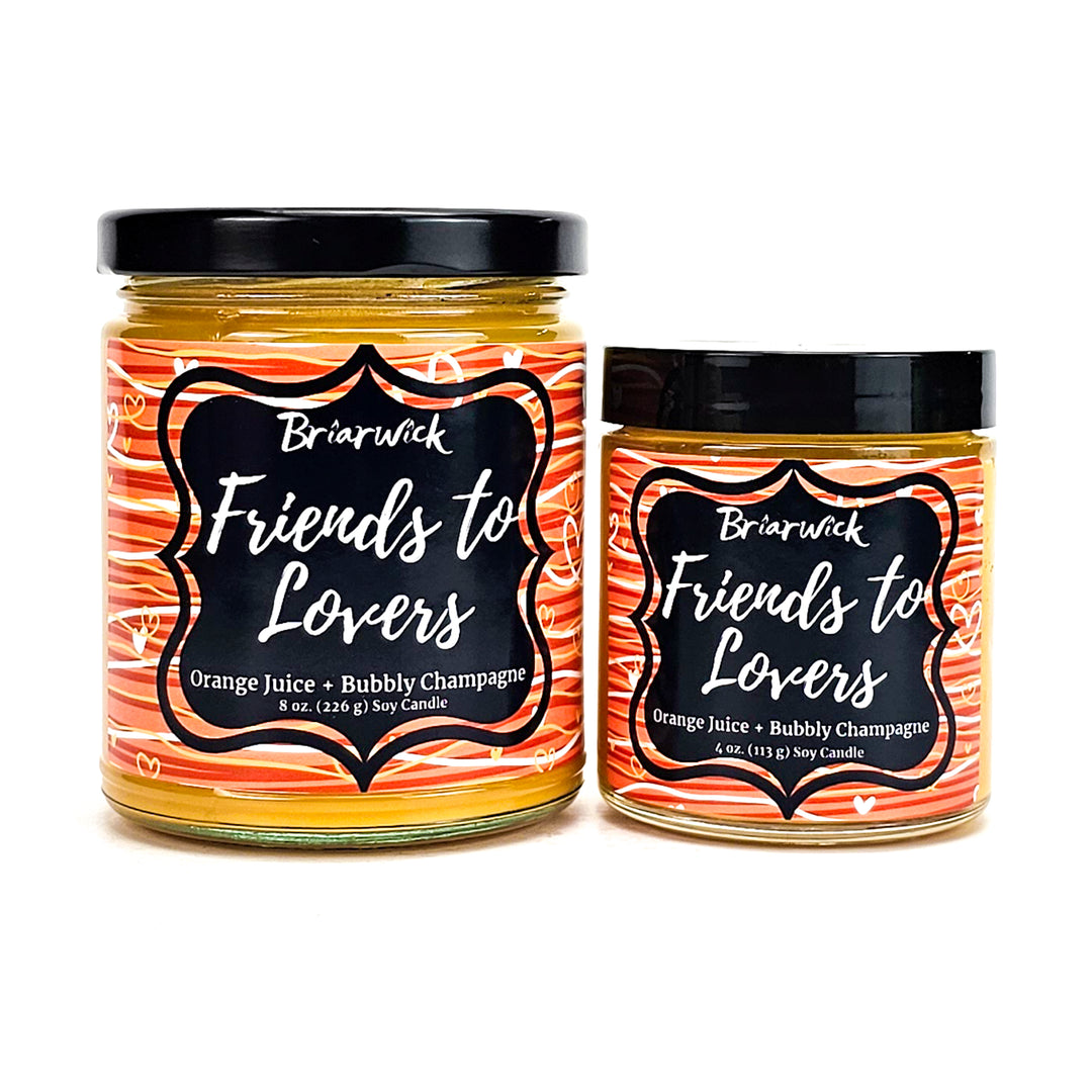Friends-To-Lovers 8oz & 4oz yellow mustard candles with white & orange line designs on a white background