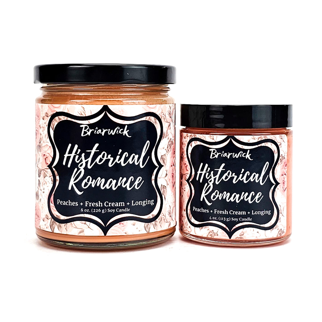Historical Romance 8oz & 4oz dusty orange candles with pale orange floral designs on a white background