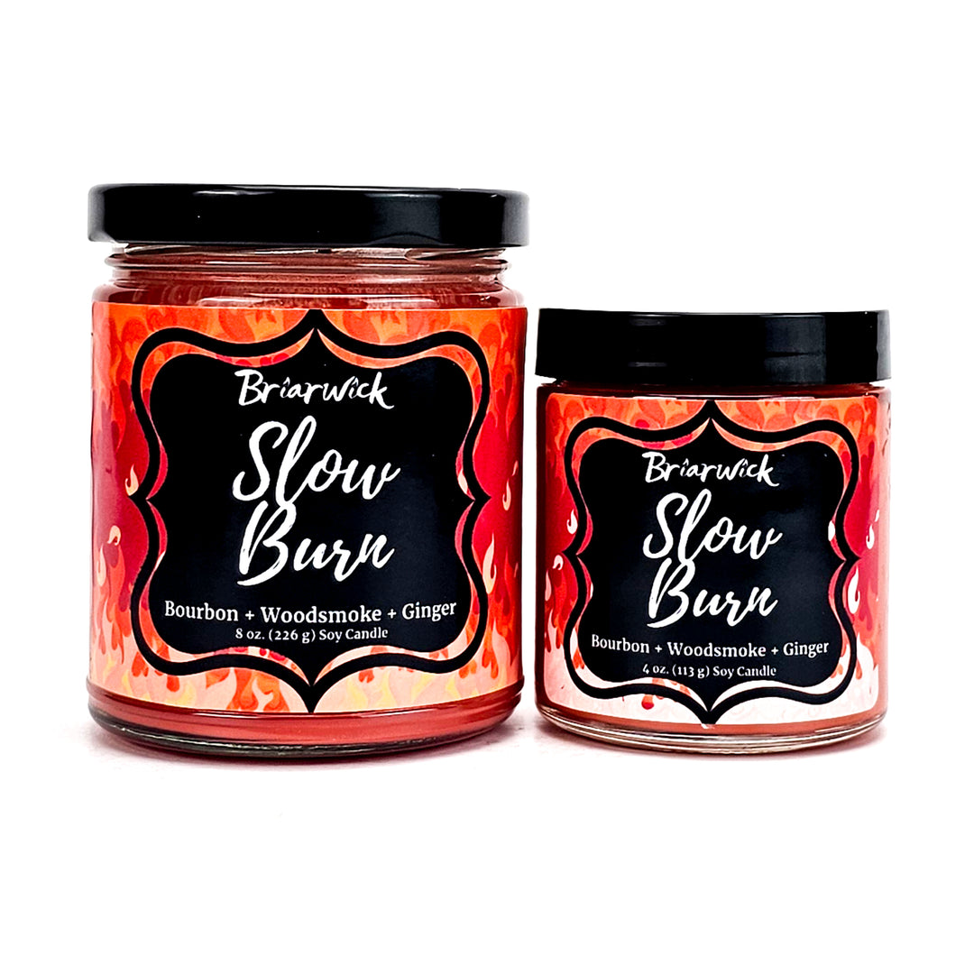 Slow Burn 8oz & 4oz persimmon candles with orange flame designs on a white background