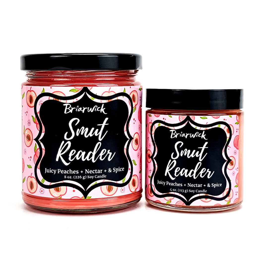 Smut Reader 8oz & 4oz dark peach candles with pink peach designs on a white background
